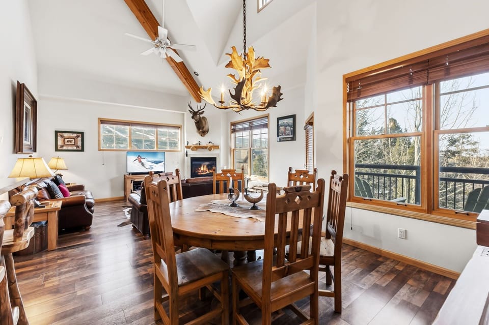 Gather around this rustic dining table where mountain views and a crackling fireplace create the perfect setting for your memorable meals together.