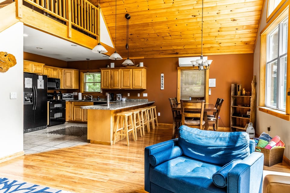 View of the kitchen and dining area overlooking the lake. Heat pump for heating and cooling.