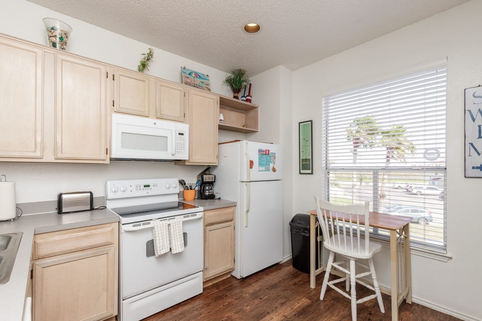 Your fully equipped kitchen features everything you need to whip up meals, from morning coffee to family dinners, with natural light streaming in.