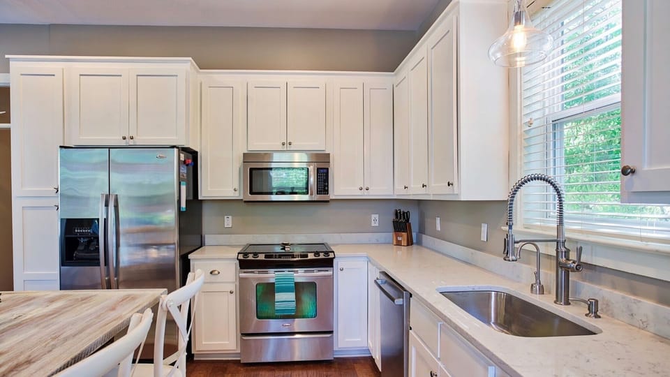 Stainless steel appliances and large sink.