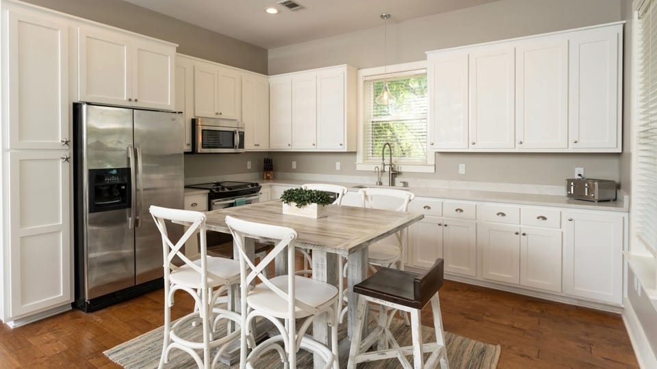 Newly renovated kitchen with quartz counters and white cabinets.