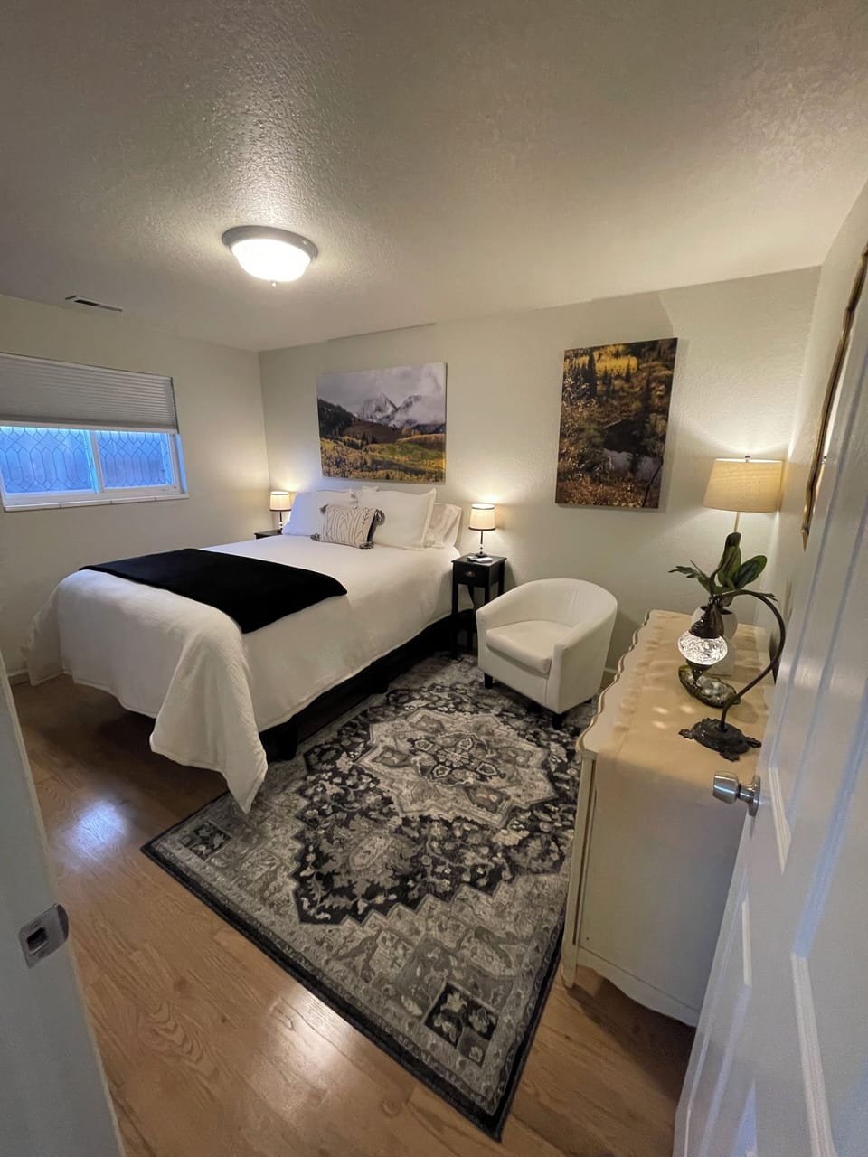 Welcome to bedroom #1 queen sized bed, blackout shades, TV, fan with remote