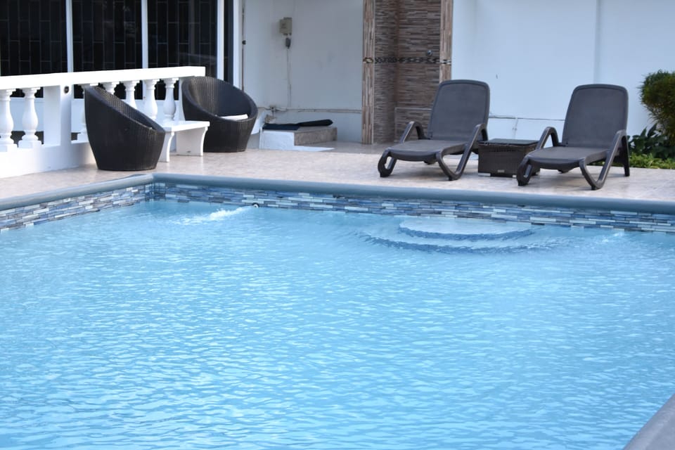 Swimming pool with 4 loungers two tables two chairs with outside shower 