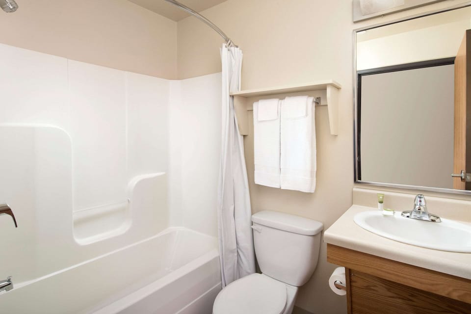 Desk, laptop workspace, blackout drapes, iron/ironing board