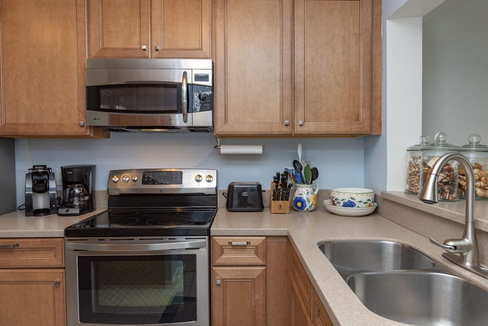 Fully stocked kitchen with plenty of tableware, cooking pots, pans, utensils - and drinking and wine glasses of every size!