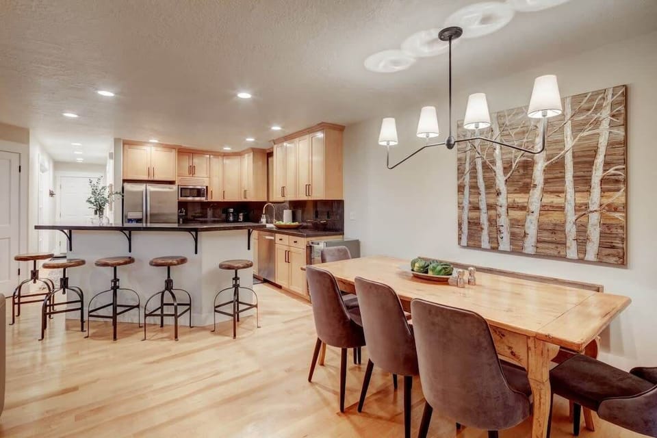 Dining Area: Stylish wood table and modern lighting, perfect for meals or game nights!