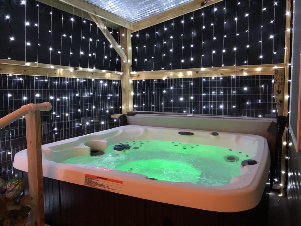 covered and screened in hot tub on lower back deck