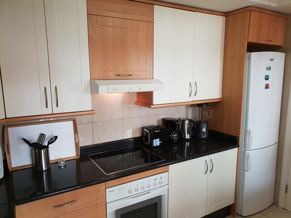Kitchen with refrigerator and freezer, electric kettle, coffee machine, dishwash