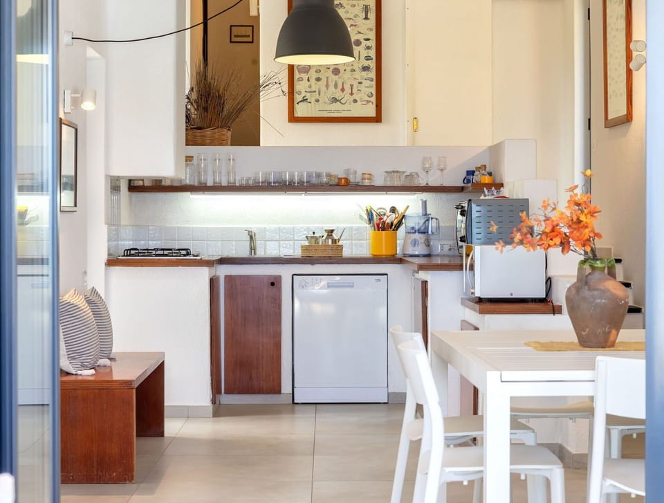 Furniture, Kitchen, Kitchen Appliance, Interior Design, Countertop, Flooring, Wall, Major Appliance, Wood, Light Fixture