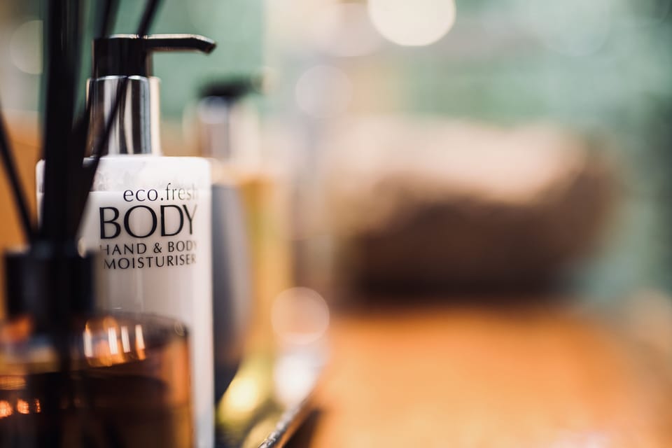 Shower, designer toiletries, hair dryer, towels