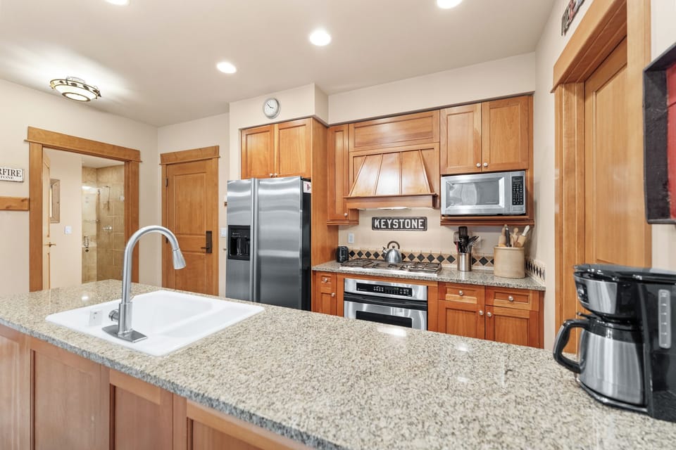 Your gourmet kitchen features granite countertops, stainless steel appliances, and warm wood cabinetry—perfect for preparing meals during your mountain getaway.