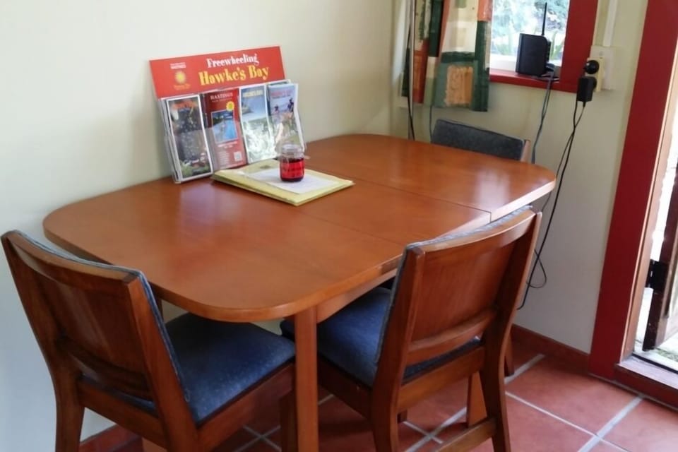 Dining Table and Chairs. Local Tourist Brochures.