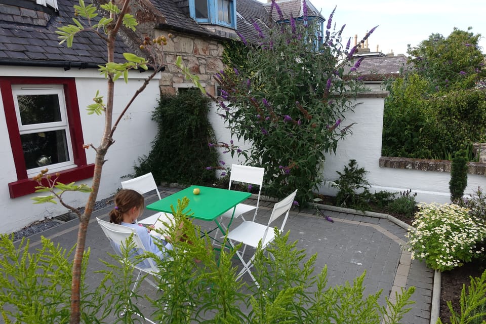Outdoor space equipped with a small outdoor table and chairs + 2 sun loungers