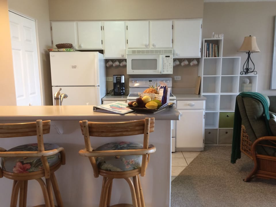 Kitchen has dishwasher & an array of small appliances and  kitchen tools
