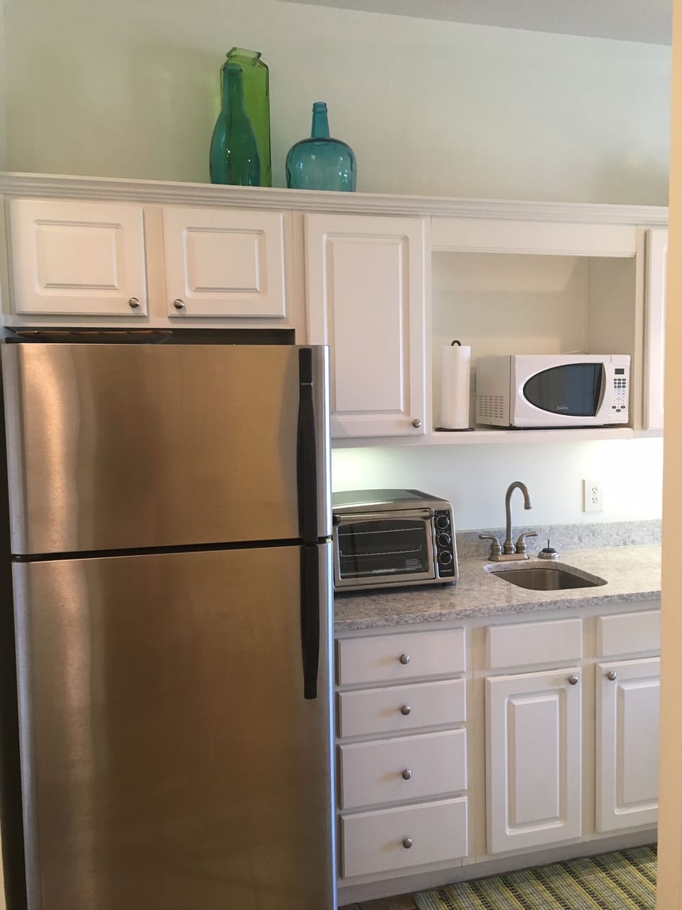 fully stocked kitchen has a refrigerator, oven, microwave and portable stovetop 
