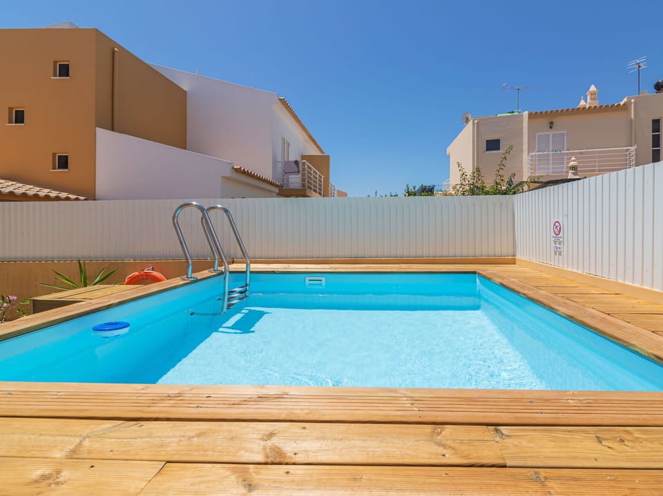 Water, Plant, Property, Sky, Swimming Pool, Light, Azure, Rectangle, Shade, Building
