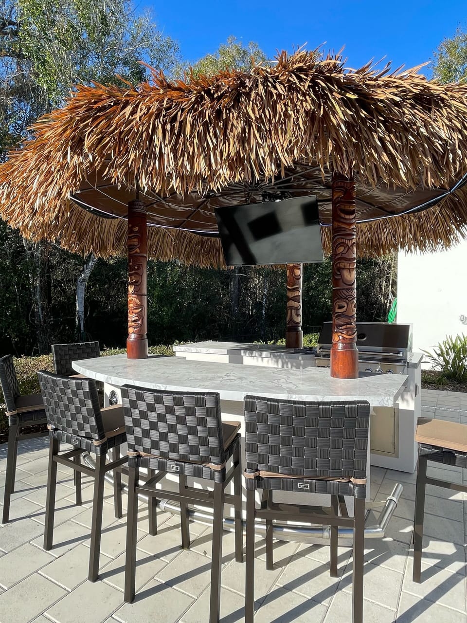 Hang out at the outdoor tiki bar with a grill, 2 fridges, TV & barstools!
