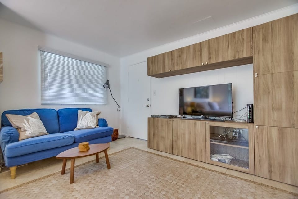 Watch a movie from the comfy couch. Entertainment center with TV and Blue Ray