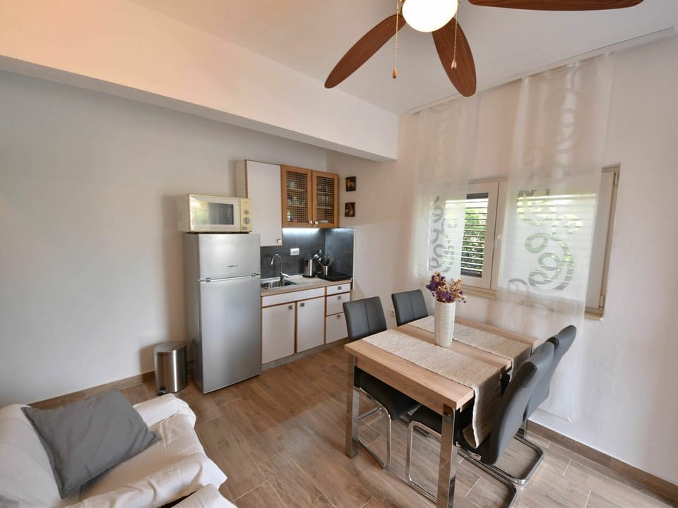 Furniture, Property, Couch, Cabinetry, Table, Countertop, Wood, Home Appliance, Interior Design, Ceiling Fan