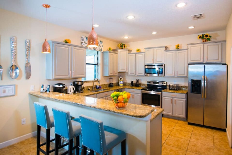 Fully equipped kitchen with multiple appliances including Margaritaville cocktail maker, Keurig and Nespresso coffee machine, waffle maker, toaster, kettle, microwave, Ninja air Fryer and more