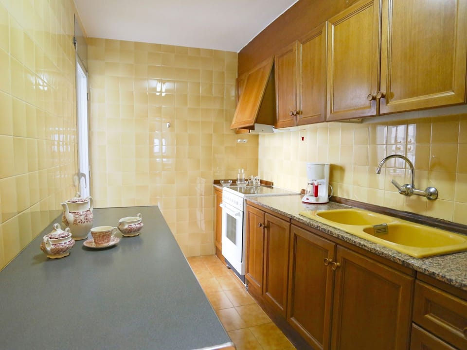 Countertop, Room, Property, Kitchen, Furniture, Cabinetry, Yellow, Building, Floor, Sink