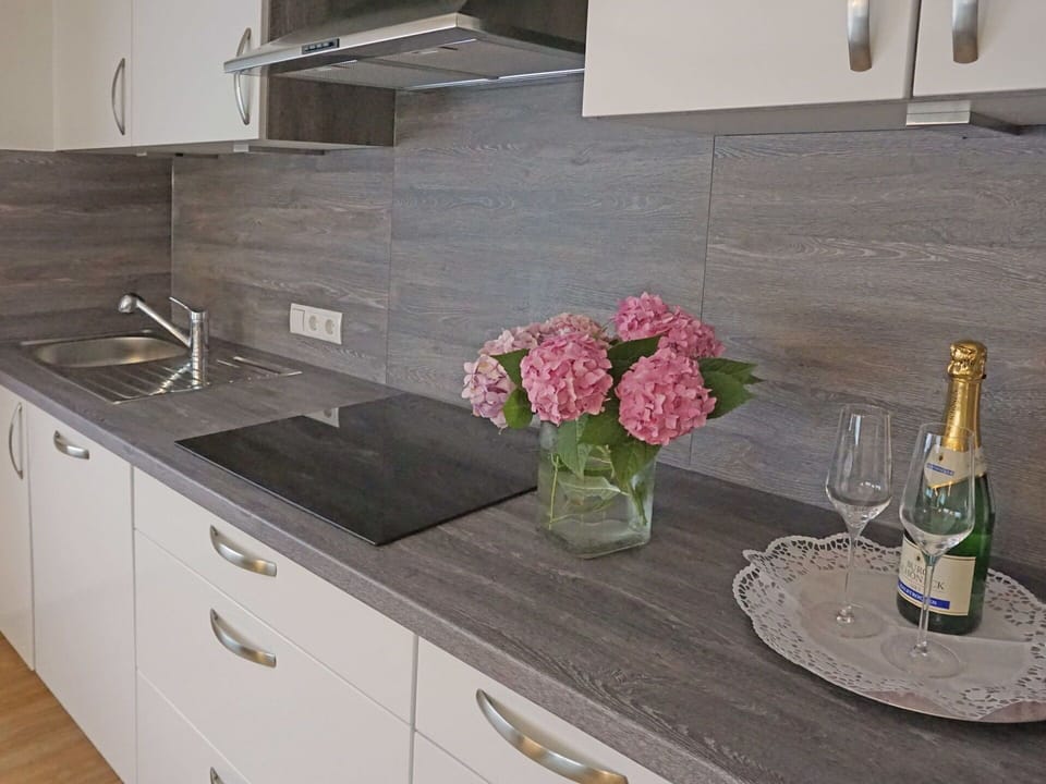Flower, Cabinetry, Property, Furniture, Countertop, Table, Plant, Bottle, Interior Design, Drawer