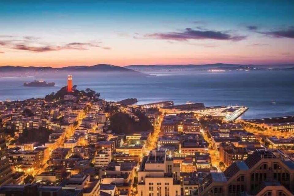 Twinkling city lights overlooking the bay at sunset—romantic, vibrant, and breathtakingly beautiful.