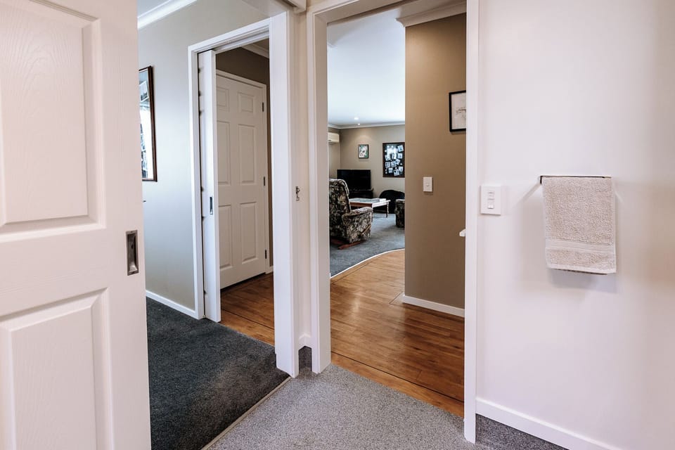 View from bathroom, leading to the main bedroom and hallway