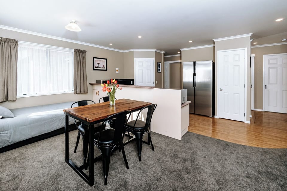 Open-plan diningroom area with 4th bed. Dining table, with 4 chairs (4 shown)