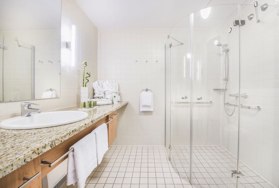 Shower, designer toiletries, hair dryer, towels