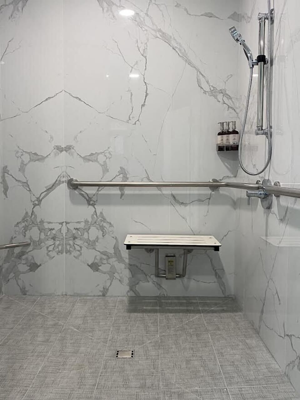 Shower, designer toiletries, hair dryer, towels