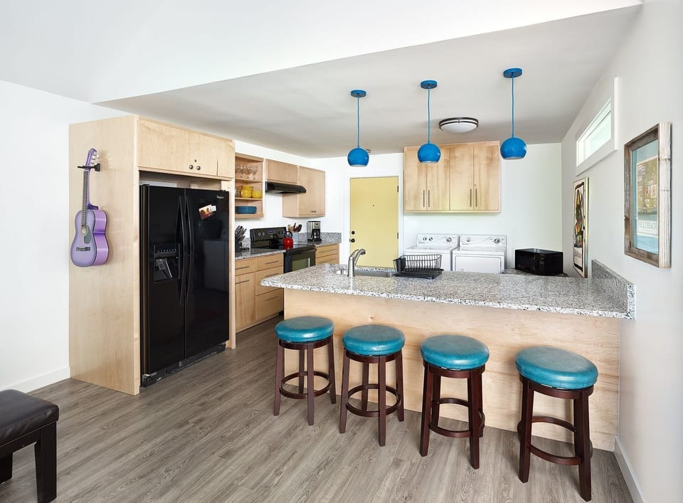 This kitchen is stocked with cookware, small appliances and utensils needed to cook and serve any meal.