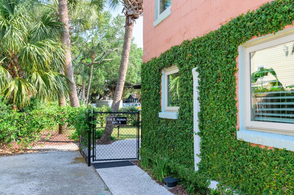 Parking area and walkway leading to the entrance through the fully fenced in yard.