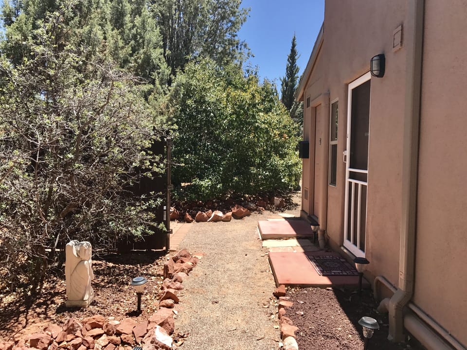 Walkway towards the entrance door (door with white frame).