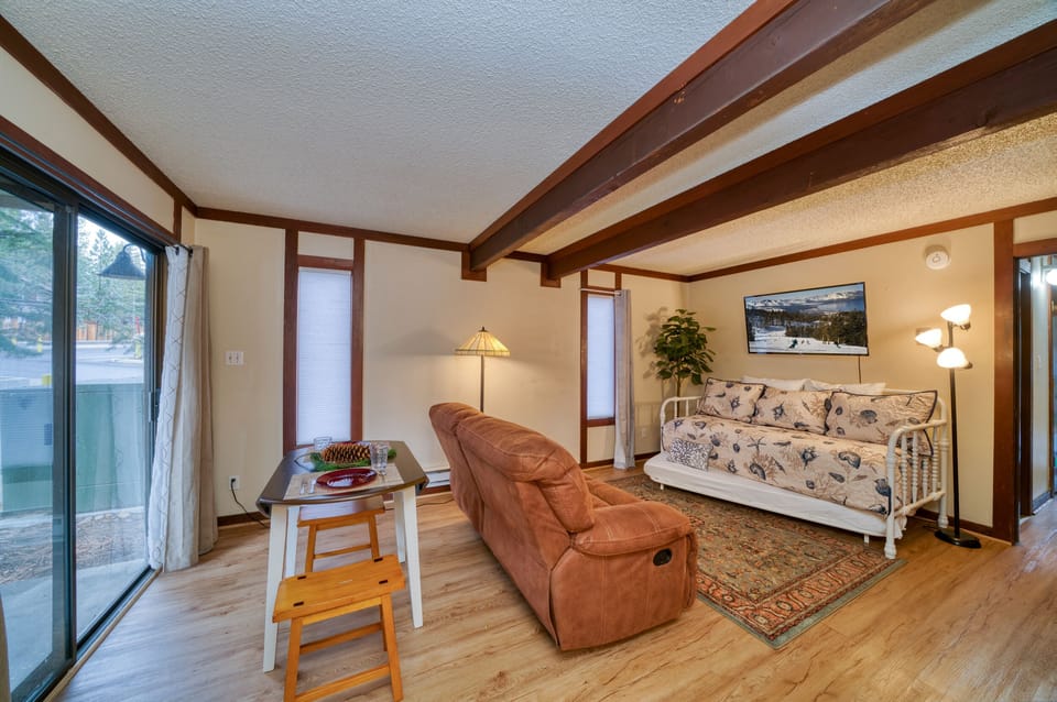 Larger sleeping/living room with twin trundle bed, TV, table & kitchenette. 