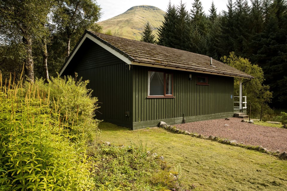 Whooper Lodge with the mountain of Ben More towering above