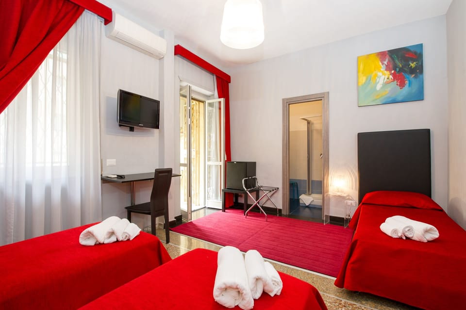 Triple Room, Balcony | In-room safe, desk, laptop workspace, blackout drapes
