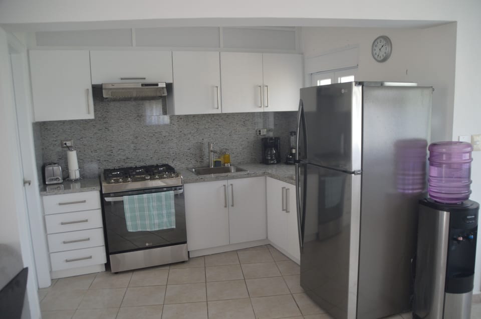 Kitchen close up view 30 gas stove\oven and large refrigerator 