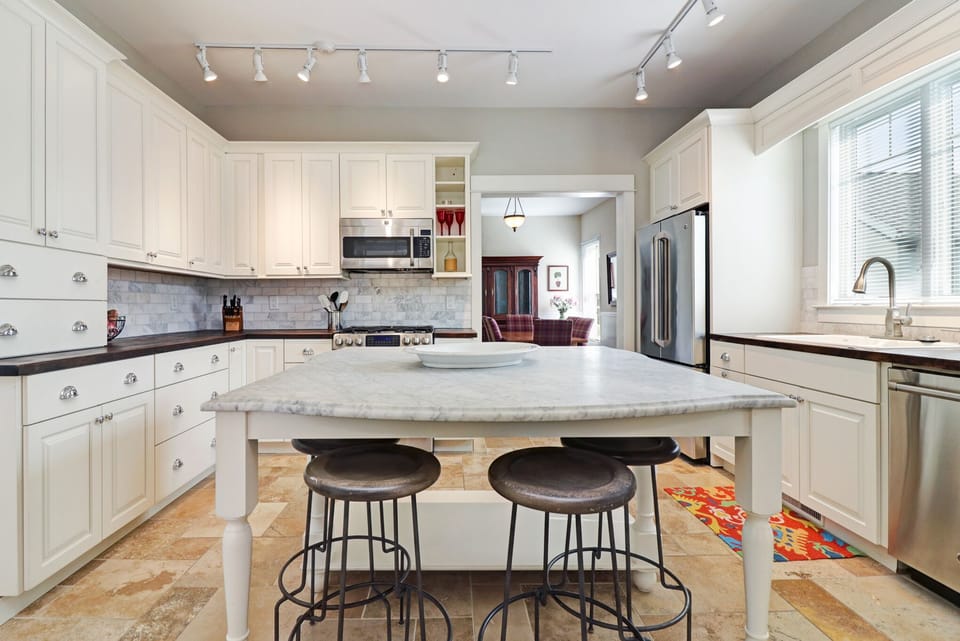 Four stools at the island provide additional seating.