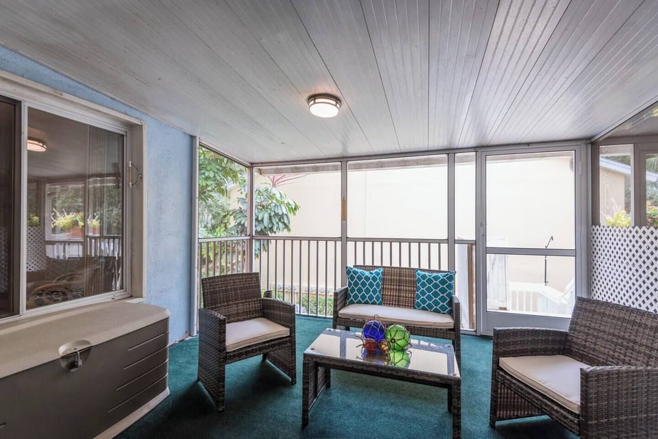 Relax on a spacious screened porch with comfortable, stylish furniture—perfect for lounging, enjoying the fresh air, and soaking in the views in complete comfort.