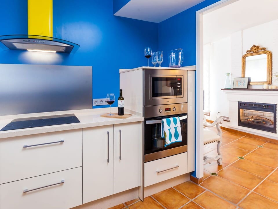 Room, Furniture, Cabinetry, Kitchen, Blue, Property, Interior Design, Countertop, Yellow, Building