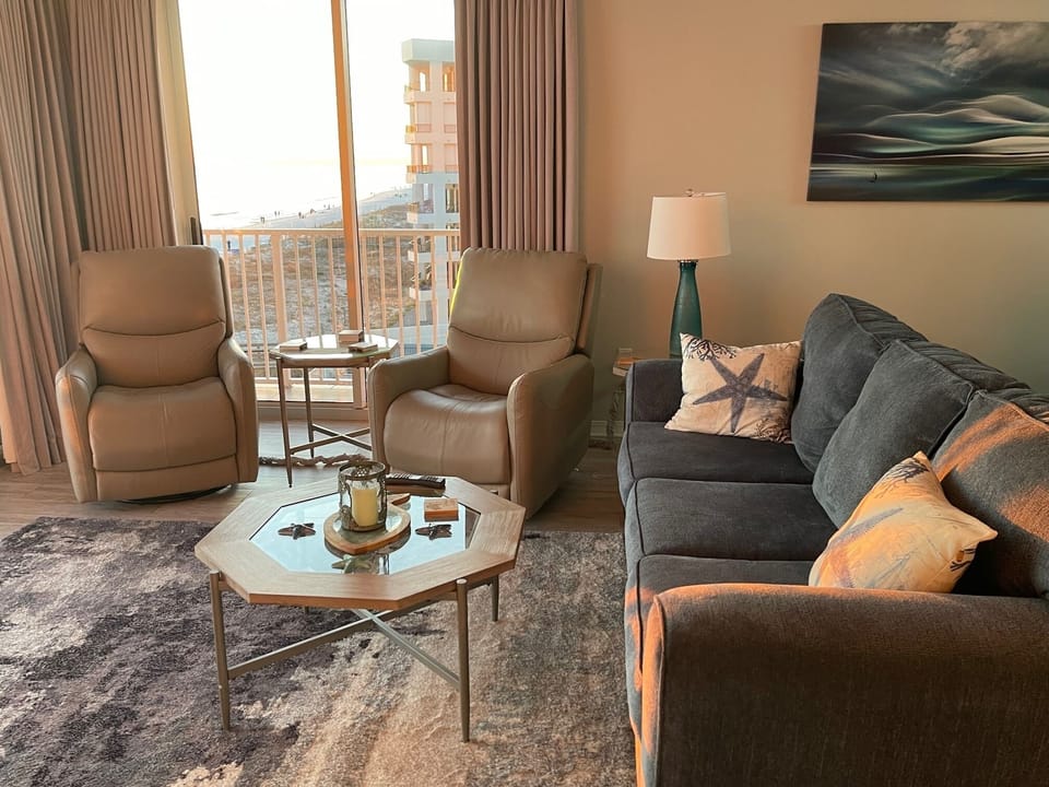 Family Room with (2) sets of slides to the ocean, (2) recliner chairs and sofa