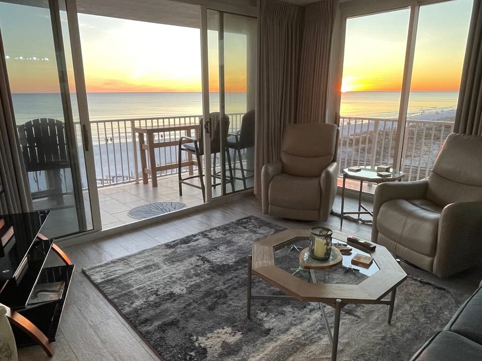 Family room, sunset view, slider doors to the balcony, 2 recliners and sofa 