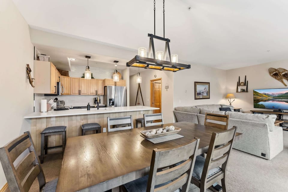 Dining Room: 6-person dining table, centrally located between kitchen and living room