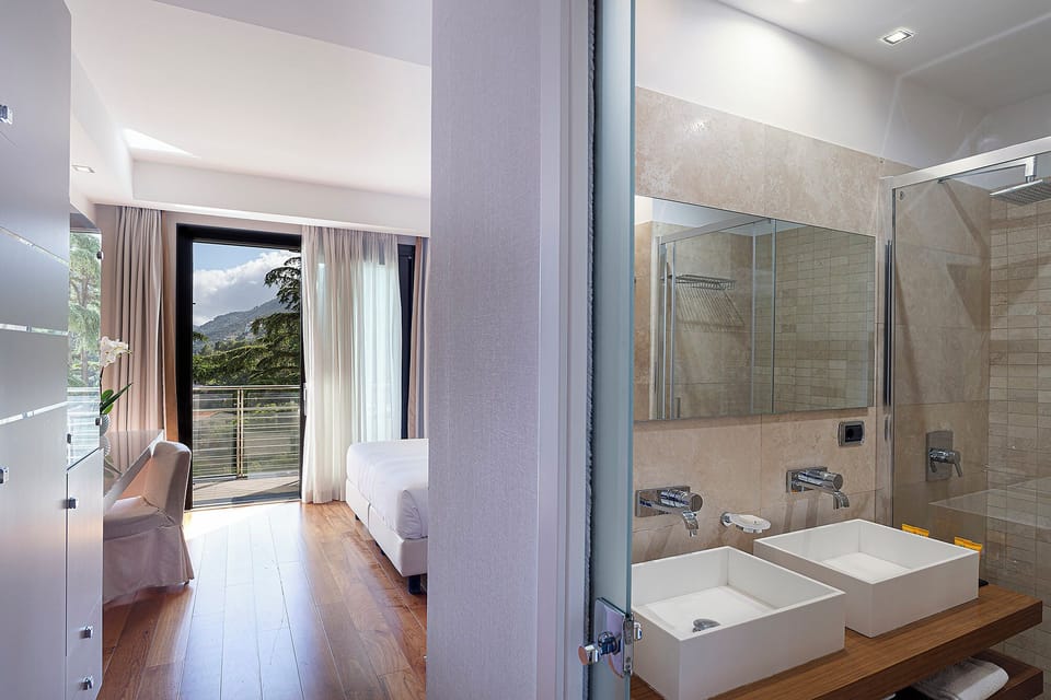Deluxe Room, Partial Sea View | Minibar, in-room safe, blackout drapes, soundproofing