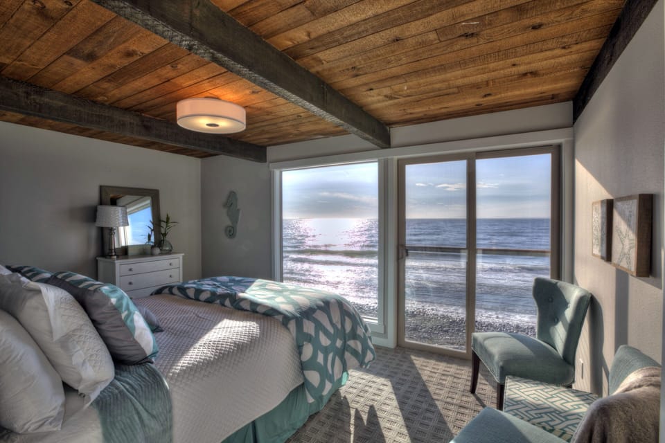 Master bedroom with a queen bed facing west. The water is right there!