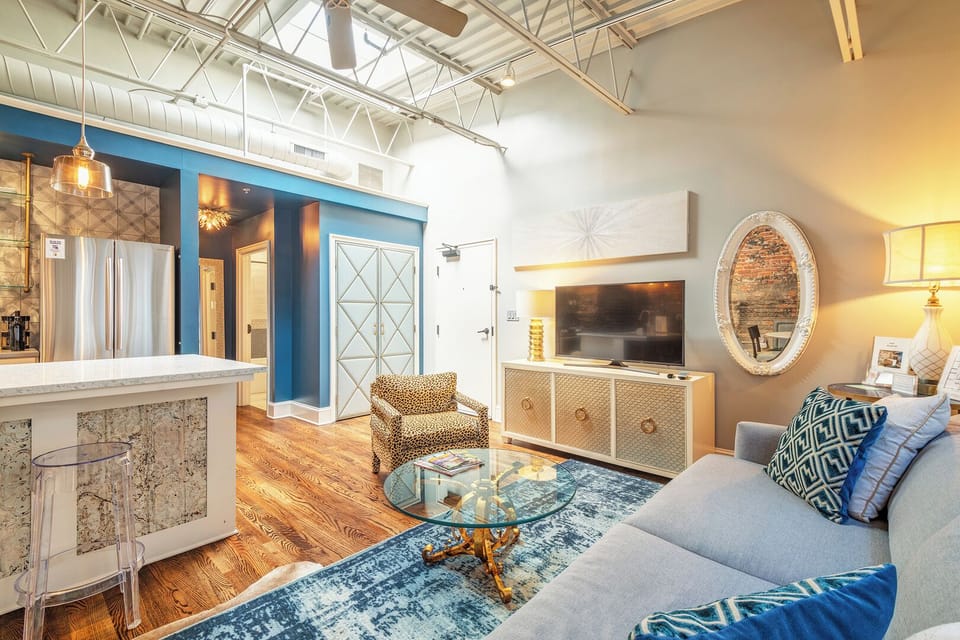 Cozy industrial loft vibes with exposed brick & handpicked vintage art—your perfect Asheville retreat.