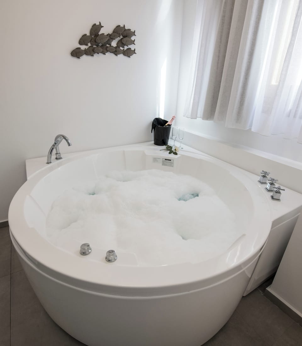 Honeymoon suite with indoor jacuzzi | Bathroom amenities | Free toiletries, hair dryer, bathrobes, slippers