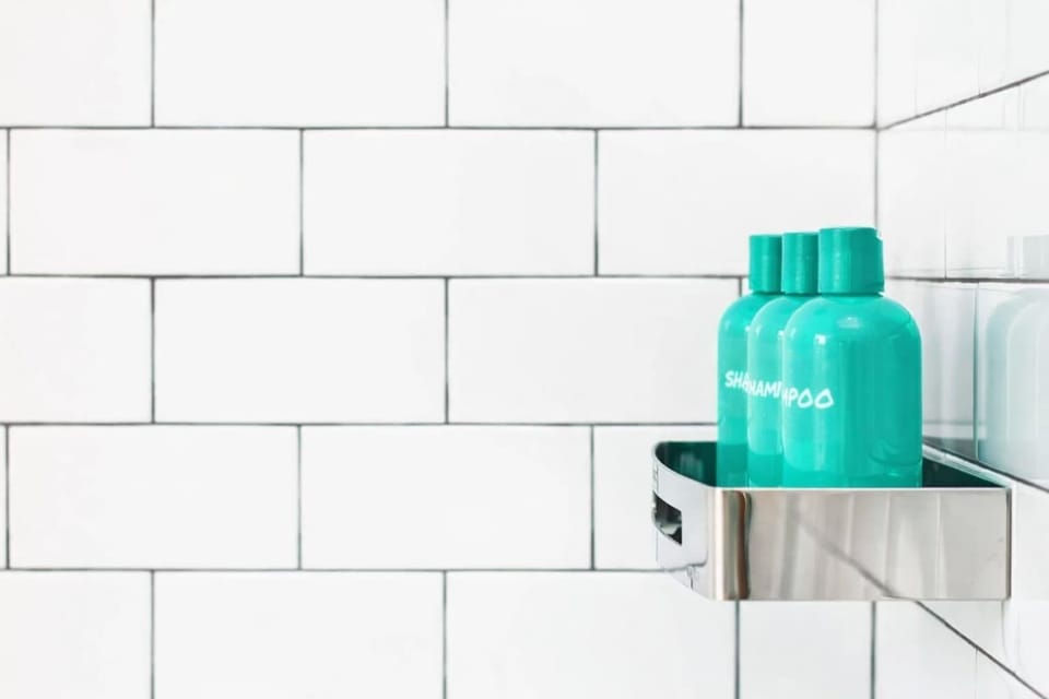 Hotel-style shower with complimentary toiletries and clean subway tile—fresh, modern, and thoughtfully stocked for your stay.

