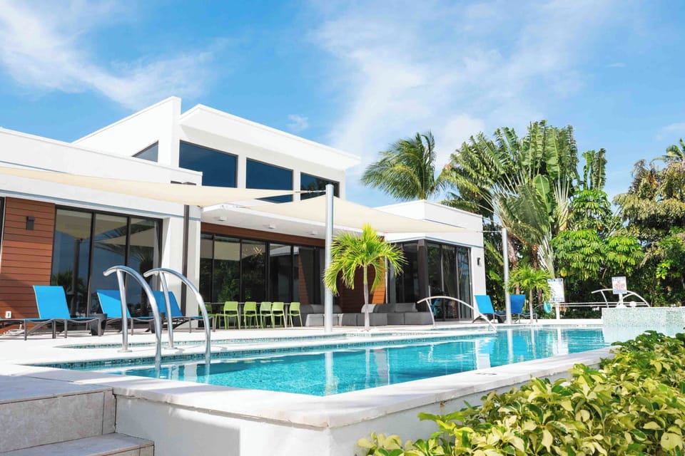 The villa's pool deck comes furnished with sun beds, outdoor furniture, and an alfresco dining table. 